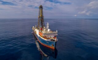 The IODP drilling vessel JOIDES Resolution on the open sea during an expedition The US drilling vessel JOIDES Resolution conducts expeditions as part of the International Ocean Discovery Program (IODP)